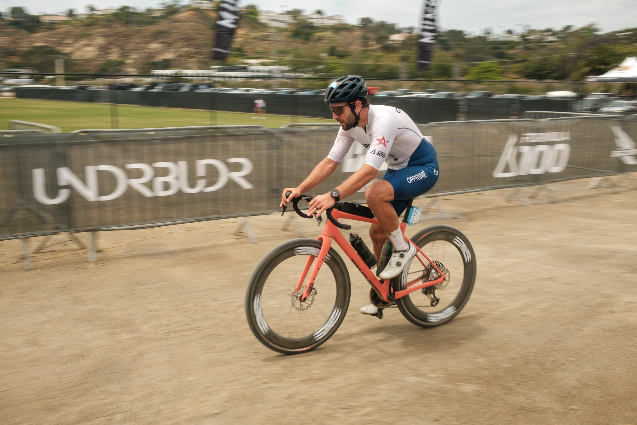 Jenson rider in white kit on an Enve MOG in motion on the dirt.