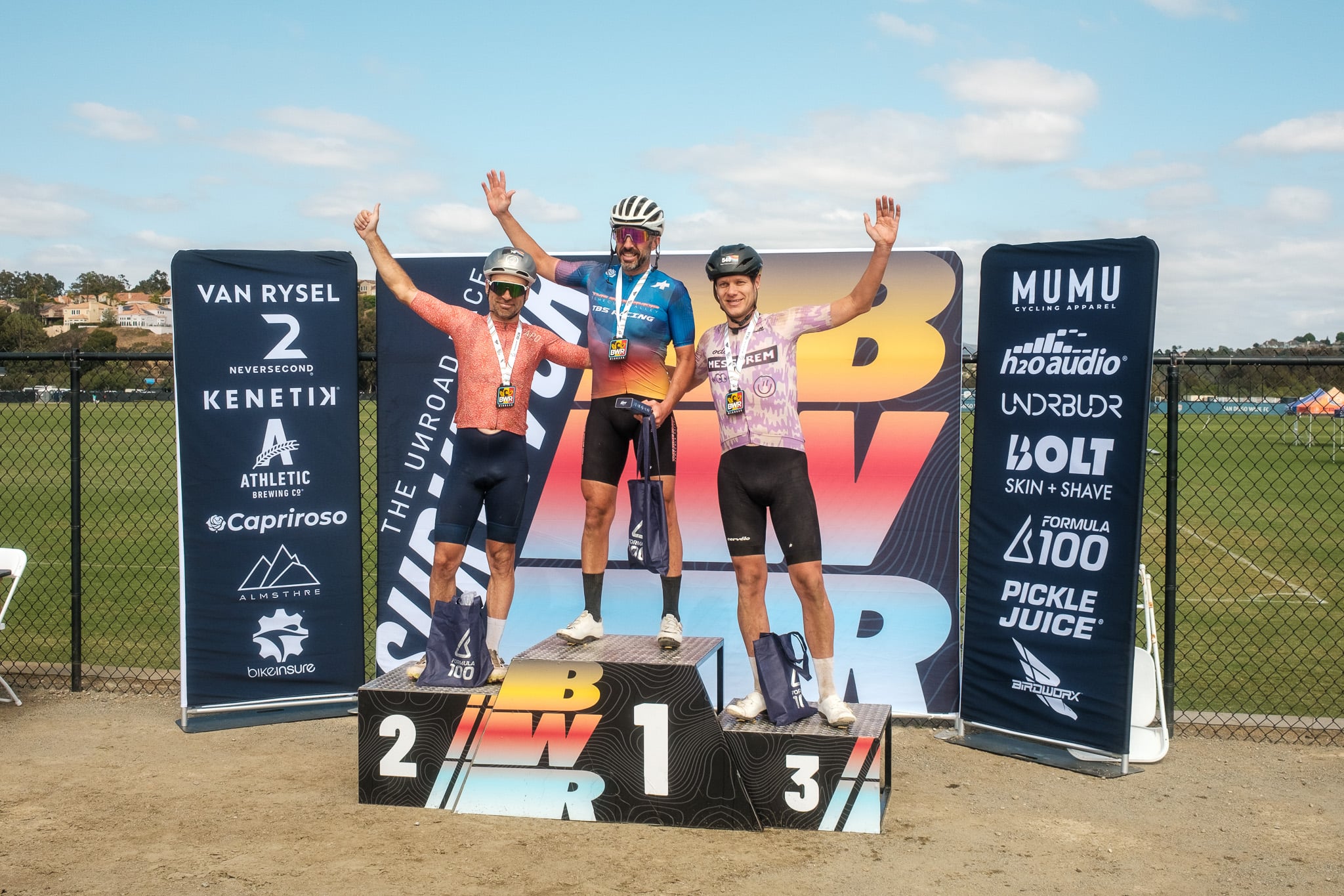 BWR Waffle age-category podium, Tamas on the 2nd place step with arms raised.