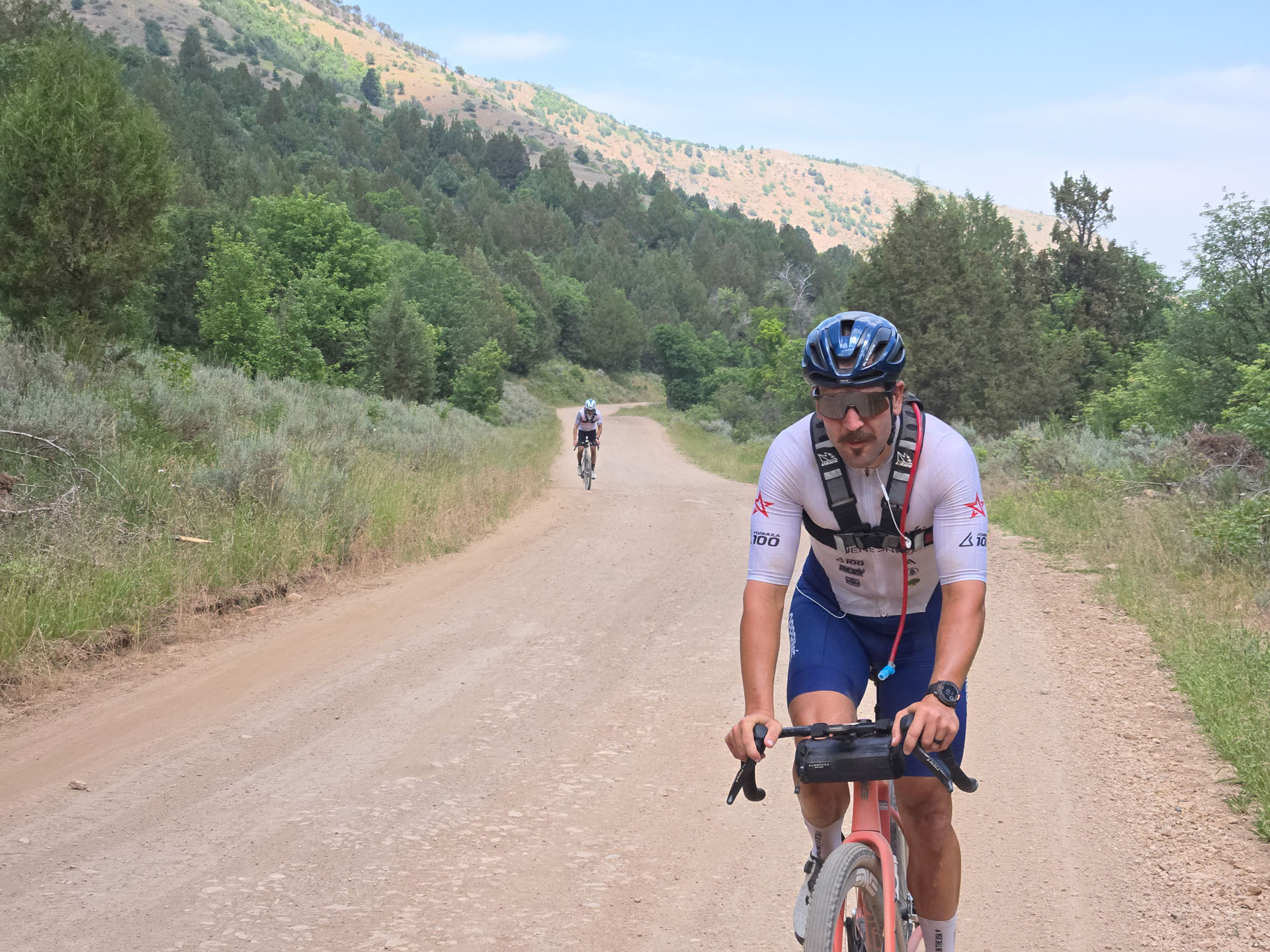 Clay, mid-ride, helmet and mustache, unbothered
