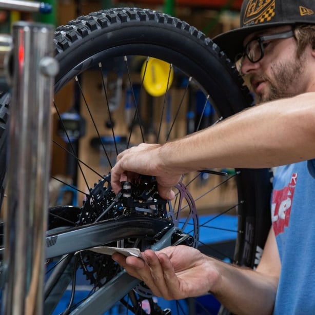A Jenson tech building and inspecting a new bike